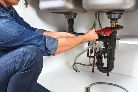 plumber working on a sink